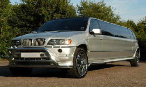 Chauffeur stretched silver BMW X5 limousine hire in London.